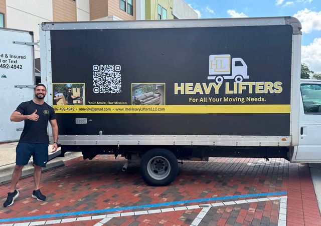 Heavy Lifters mover next to the Heavy Lifters box truck