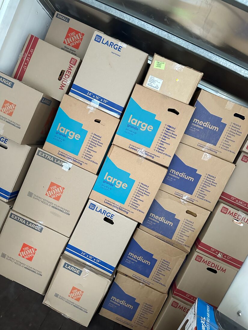 Neatly stacked and labeled moving boxes packed by Heavy Lifters — movers serving St. Augustine, FL