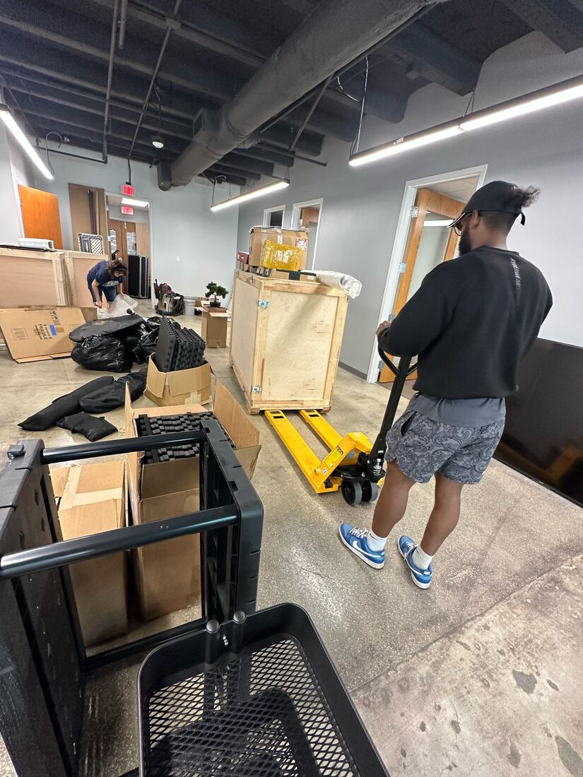 Heavy Lifters crew moving boxes with a dolly — movers serving Jupiter, FL