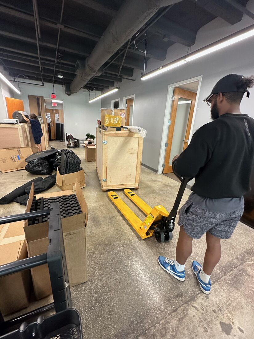 Heavy Lifters movers carrying items through a hallway — movers serving UCF, FL